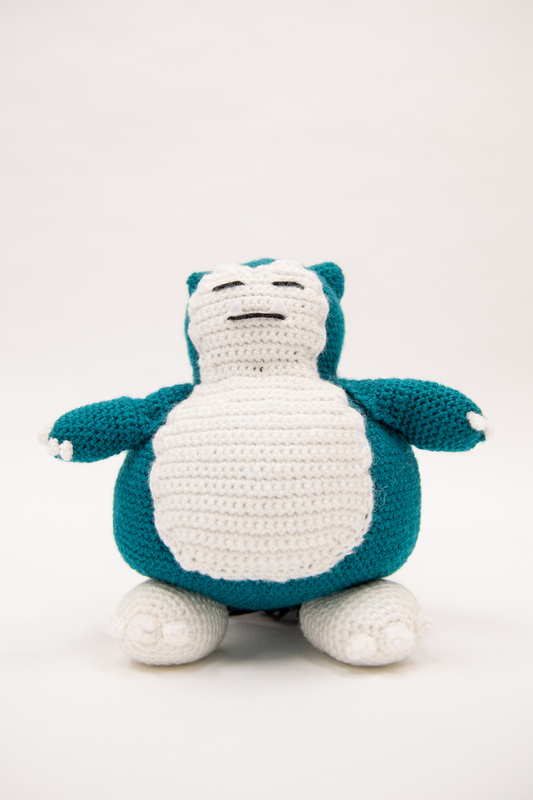 Image of a crocheted Snorlax from the front. 