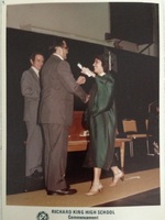 Arturo Vasquez, handing his daughter Valerie, her  high school diploma.