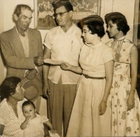 Photograph of AGIF members presenting a check to Guadalupe Vera and his family to support the poor. 