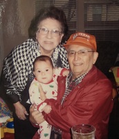 Marie and Arturo Vasquez holding their youngest grandchild, Claudia.