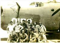 WWII, 330th Bomb Squadron, 93rd Bombardment Group: Arturo Vasquez with officers, and air crewmen, in front of a B24 Liberator. Black and white photograph. 