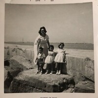Marie Vasquez with her three oldest children, standing on the Corpus Christi seawall.