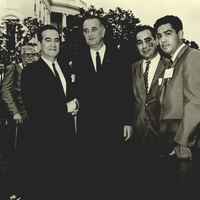 Photograph of Dr. Garcia, President Johnson and AGIF chairmen Augustin Flores and Corky Gonzales posing for a photo in front of the White House. 