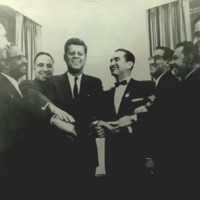 Photograph of John F. Kennedy with Viva Kennedy club leaders. 