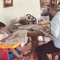 Arturo Vasquez, and grandson Gabriel, reading the newspaper. 