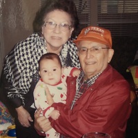 Marie and Arturo Vasquez holding their youngest grandchild, Claudia.