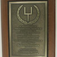 A plaque of Thoughtful Service from the Board of Directors of the Driscoll Foundation Children's Hospital to Arturo Vasquez.